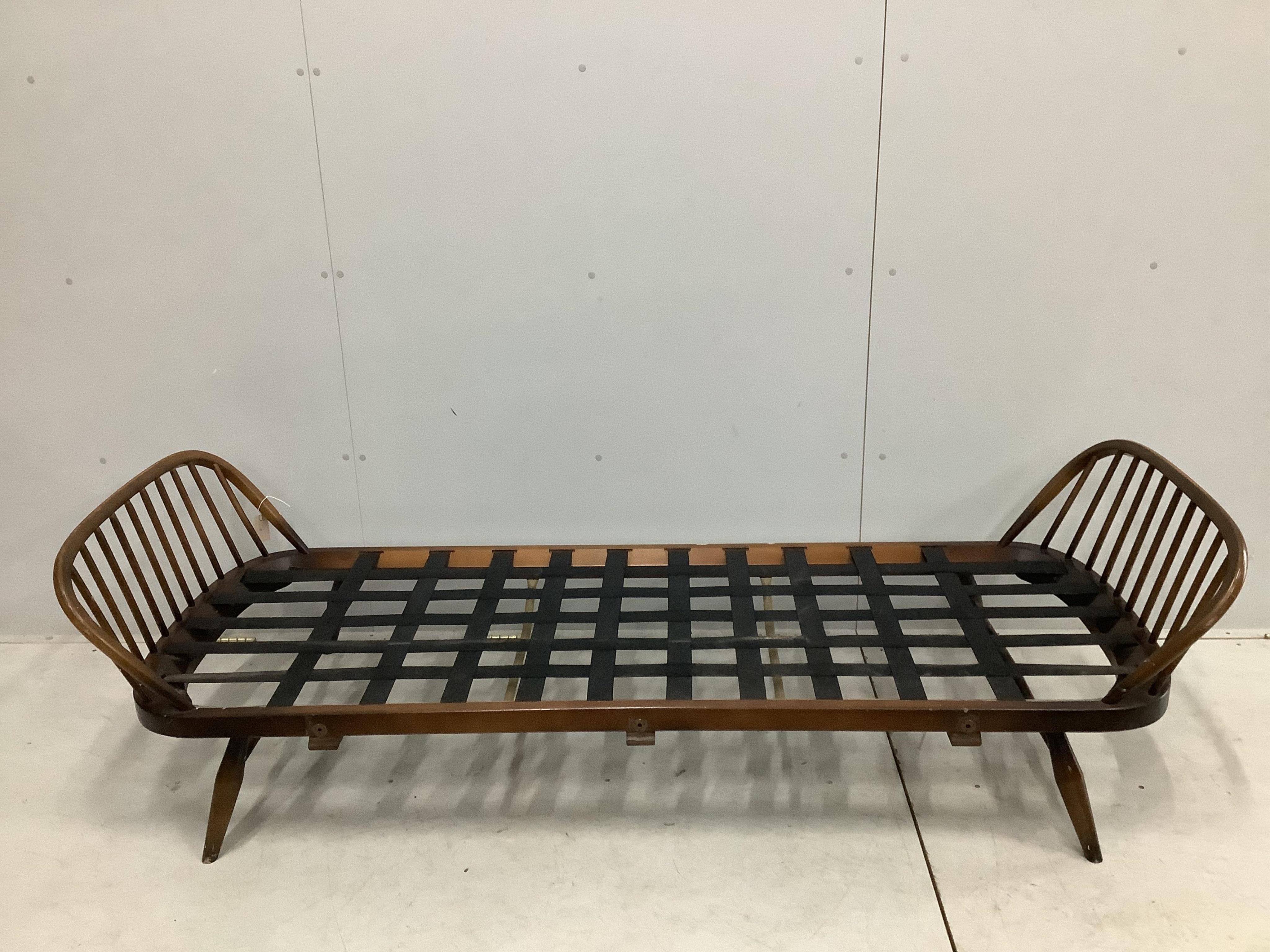 An Ercol day settee, width 208cm, depth 73cm, height 70cm. Condition - fair but missing bolts for side rail